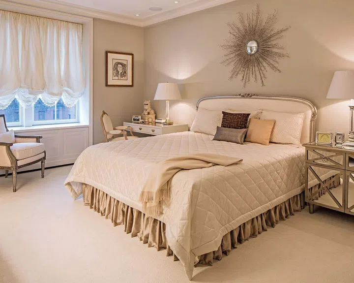 The Louis J Solomon headboard is framed in a silver leaf with Jagtar Thai silk upholstery. The writing desk in the corner with a white gold finish is from Nancy Corzine and it is paired with a Lucite desk chair from Plexicraft.