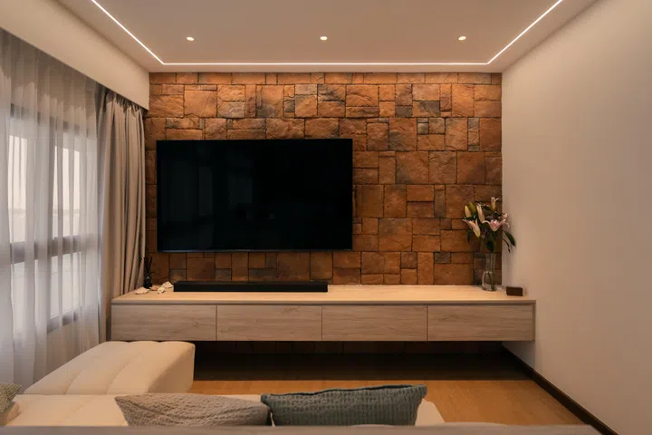 A floating console and soft cove lighting highlight the stone’s natural texture while keeping the compact space visually light.