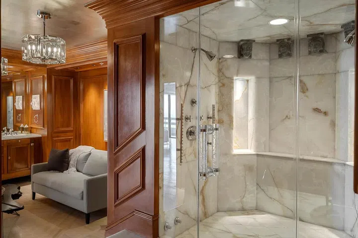 The primary suite's onyx-clad bathroom is uniquely beautiful.