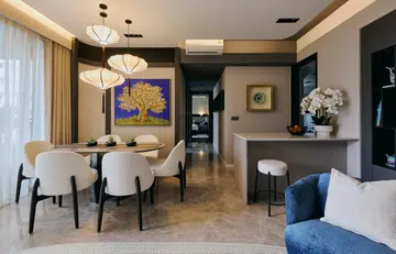 An open layout links the dining, kitchen island, and living spaces, creating flow and connectivity.