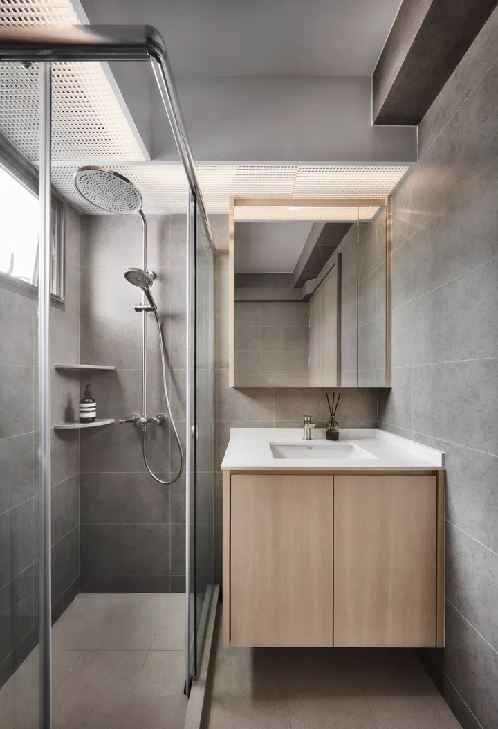 Clean finishes and clever storage make the compact bathroom feel streamlined and easy to maintain.
