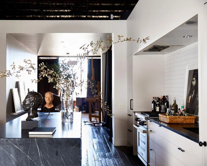 In young artist William Rushton's quiet home, the interiors respect the cragginess of the loft’s envelope by exposing the ceiling’s metal joists, and leaving the old brick walls, the steel windows, and the original wood floors as they were. Designed by architect Paul Bates. Credit: Brie Williams