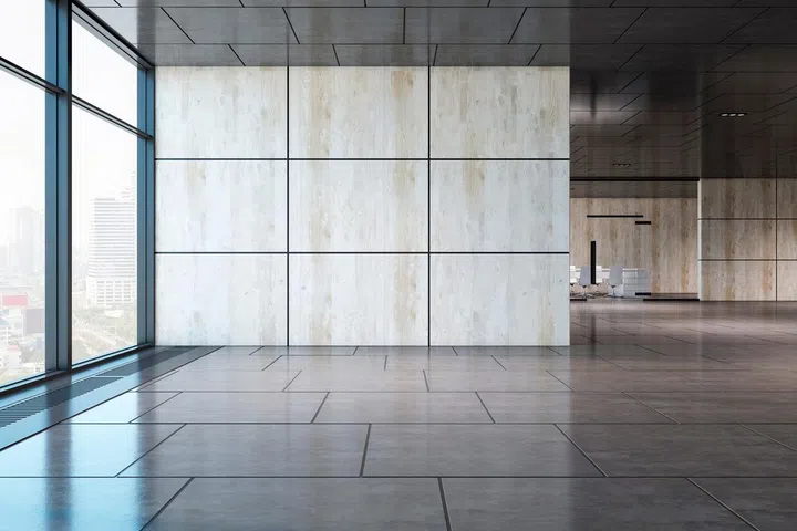 Front view on empty wall with place for advertising poster in spacious business center office with city view from window, squared tiles floor and conference room on background.