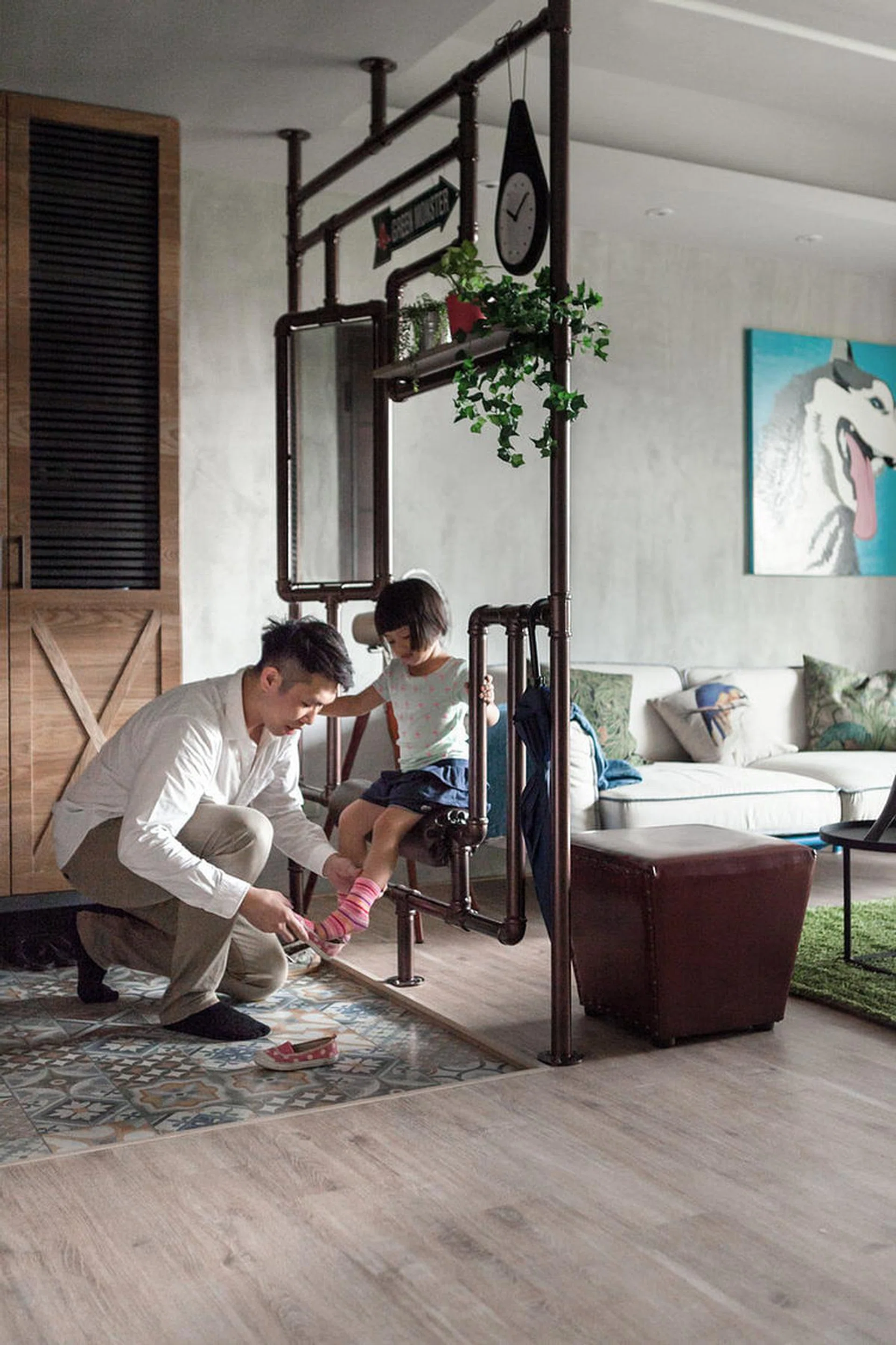 Our favourite element of this barn-style Industrial home for a Taiwanese family: a steel seat that makes taking off and putting on shoes so much more stylish!