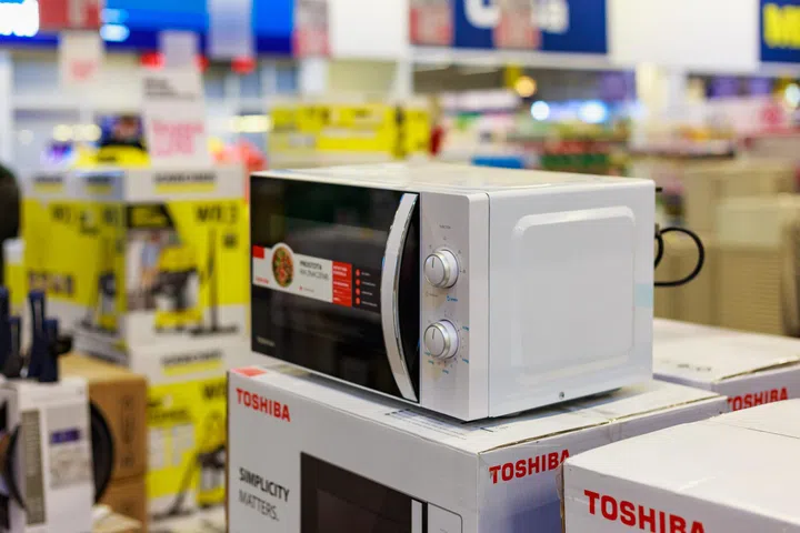 March 23, 2021 Balti Moldova supermarket or wholesale hypermarket. Department of goods for the kitchen. Illustrative editorial. Showcase with microwave ovens.