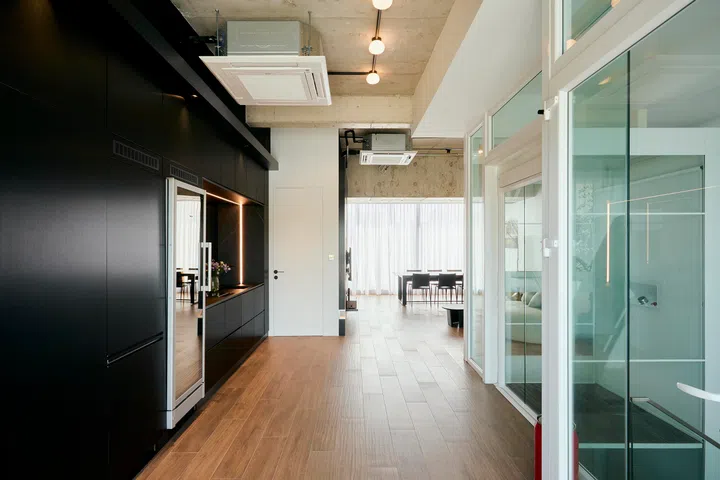 The glass lift offers a different experience from conventional enclosed lifts, with transparency that allows movement to remain visually connected across levels.