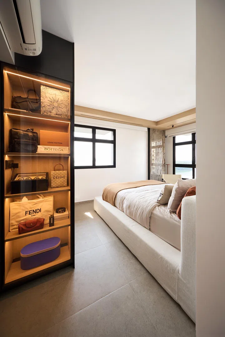 Handbag display cabinet within the master bedroom in a couple’s 4-room BTO (1,001 sq ft) in Punggol.