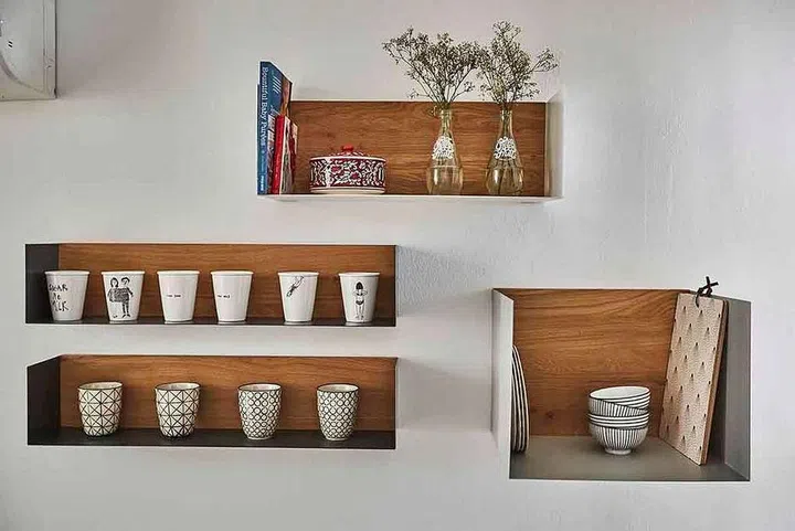 Minimalist wood open shelves in a white kitchen. Show off your uniformed set of glassware. Interior Design by Ethnicraft