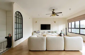 A snapshot the dining area leading to the living room. Wall sconces are used throughout the home. 