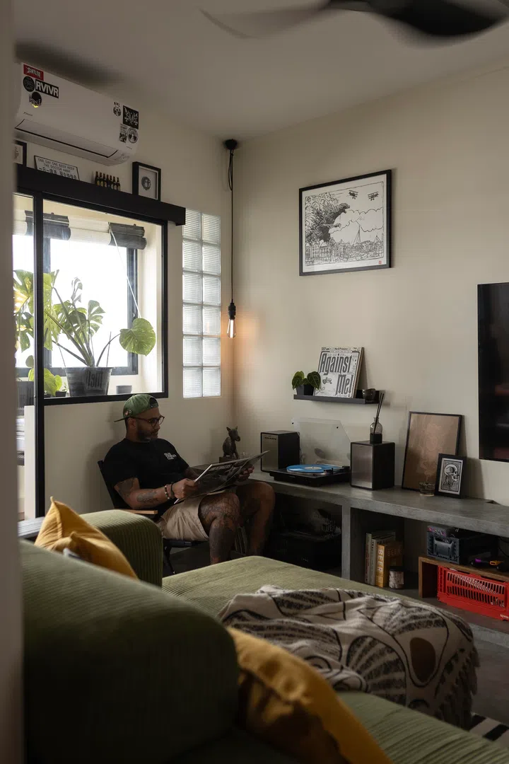 A sliding door separates the living room and balcony.