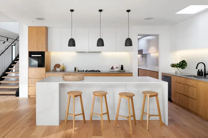 Dining room with kitchen island in all wood and white.