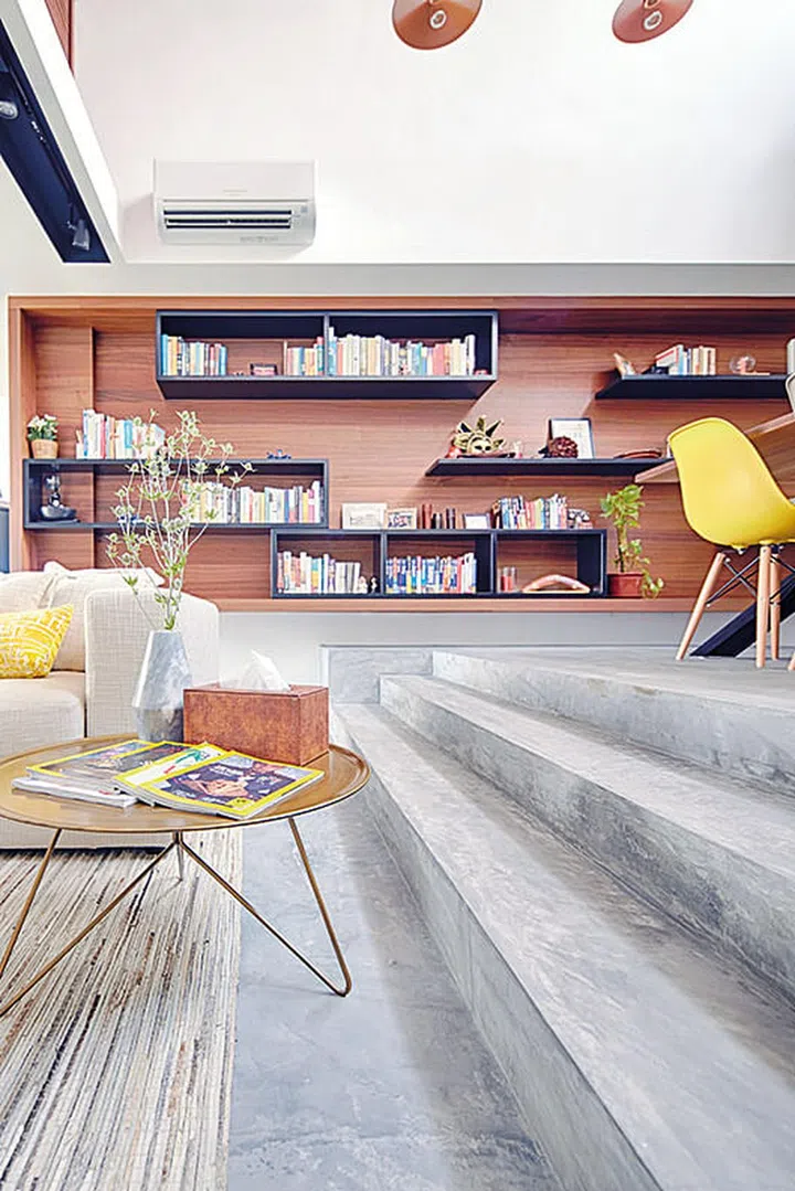 The display shelves are filled with cookbooks and travel souvenirs to bring a decorative touch to the living and dining space. The Link coffee table is by Miniforms, from Xtra. Vase from Galanga Living.