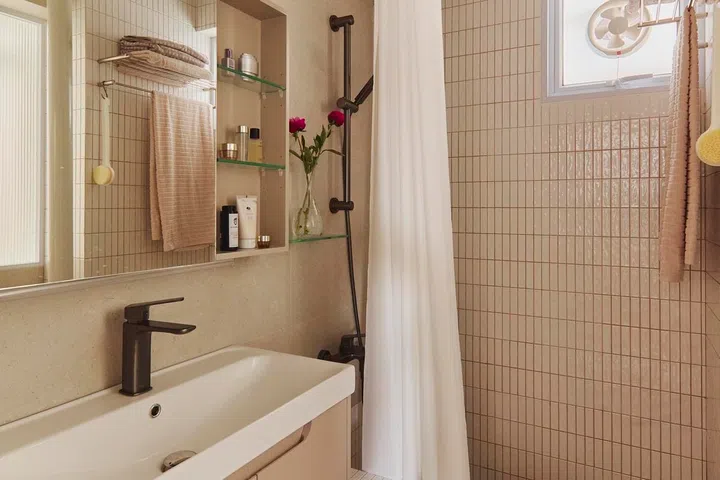 The bathrooms were fully refreshed during the renovation, with warm neutral finishes and practical upgrades designed to improve everyday comfort.