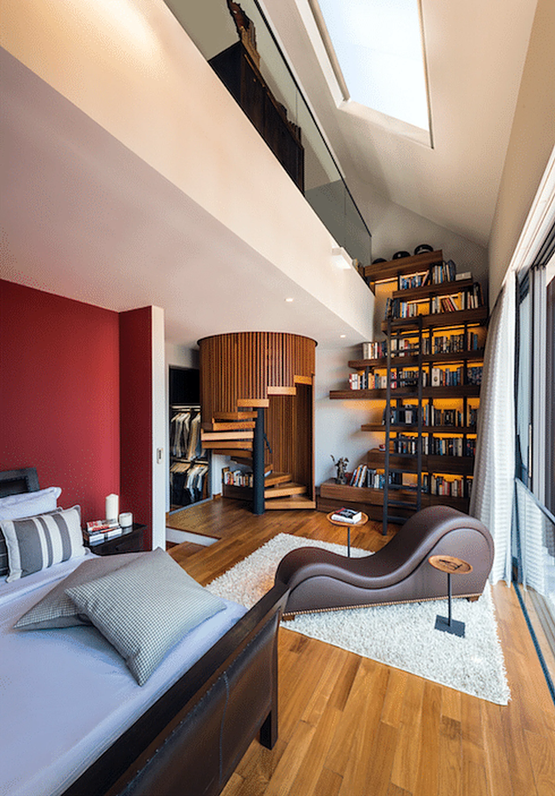 The spiral staircase is a vertical circulation element that establishes a physical connection between the two levels.