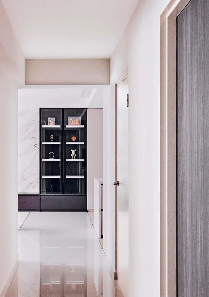 The living room feature wall incorporates glass display cabinets.