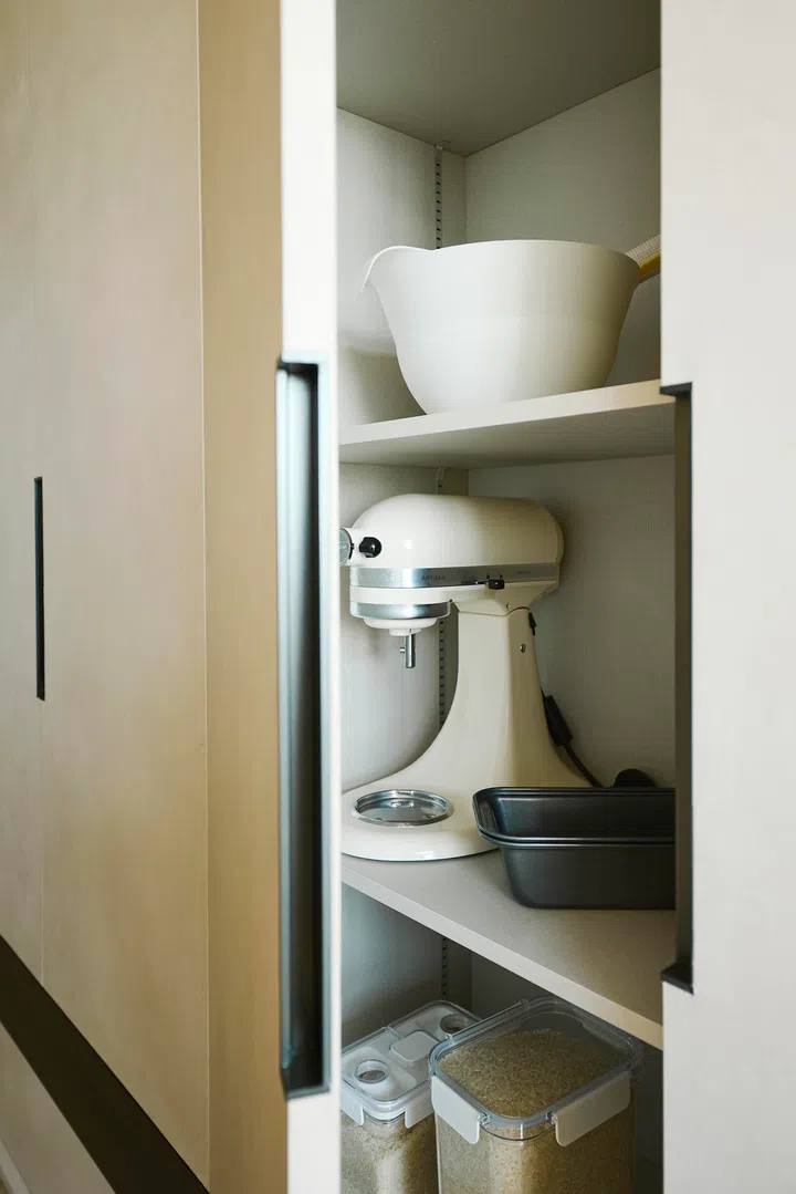 Cleverly concealed cabinets and built-in compartments ensure a clutter-free kitchen, blending form with day-to-day practicality.