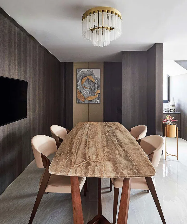 Rich dark wood panels line the walls in the dining room of the Kareem family’s 4-storey terrace house in Telok Kurau.
