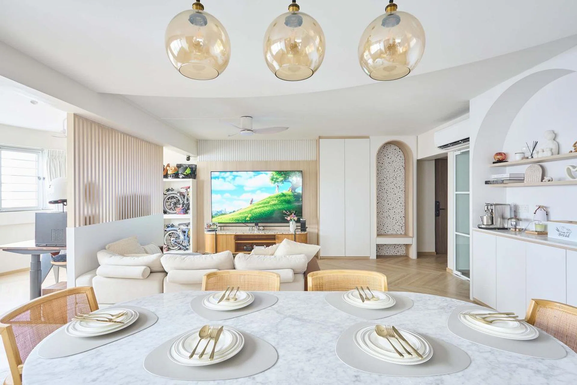 The living room feature wall echoes the fluted detailing beside the pantry, which helps to tie the scheme together.