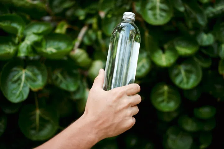 Hand Hold Water Transparent Glass Reusable Bottle. Clear Healthy Drink in Zero Waste Natural Container. Nature Purity Concept for Environment Friendly Bottled Aqua. Fresh Spring Purity.