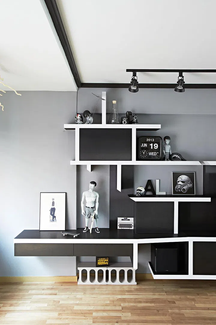 Get creative with the placement of your collectibles on a wall full of open shelves of varied widths. Interior design by Space Sense