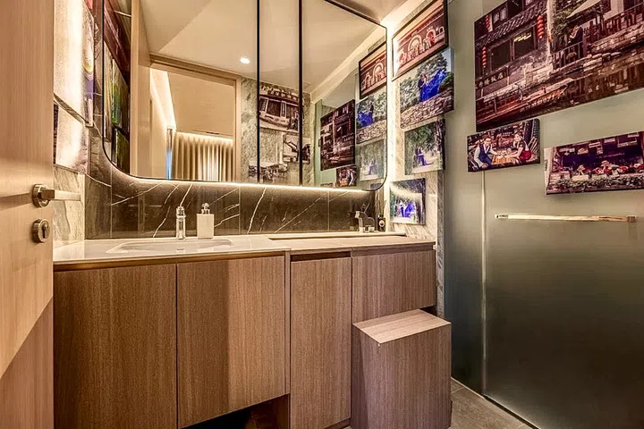 Travel photographs transform the master bathroom into a nostalgic gallery of memories.