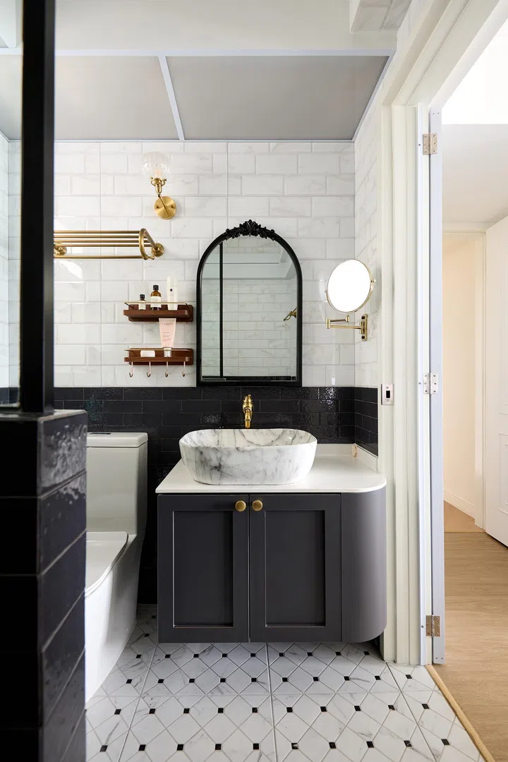 The bathroom with blue subway tiles.
