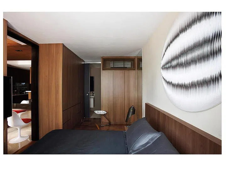 A leather art piece from Ode to Art contrasts with the industrial-style lamps from Xtra Park Mall and the strong lines of the built-in bed.