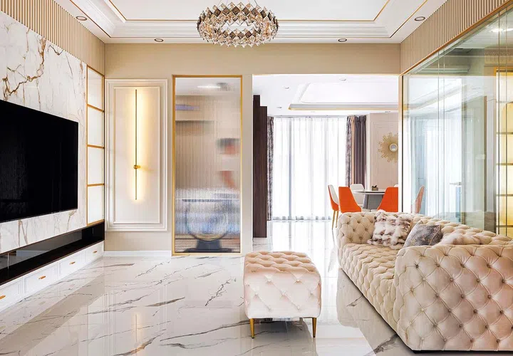 The combination of marble, gold, and the iconic white chesterfield sofa epitomizes the epitome of modern rococo interior design, transforming the living room into a realm of refined luxury and timeless beauty.