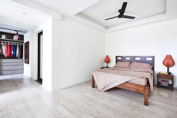 Upstairs, the master bedroom is kept almost bare to enhance its spaciousness.