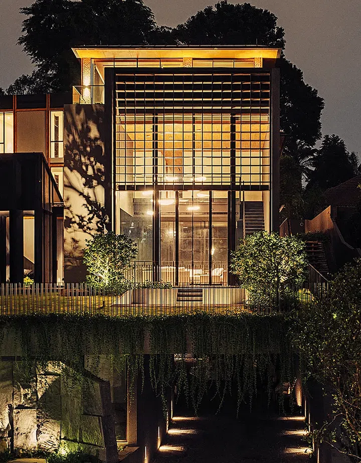 The main entrance is through the garIn the evening, the upper floors of the bungalow glow like a jewel above the driveway, which is dimly lit to create the feeling of entering a cave. (Photo: Khoo Guo Jie)