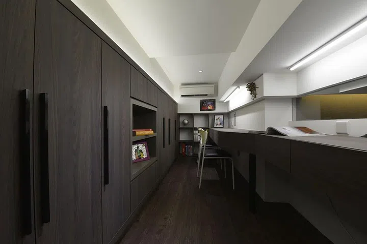 Dark wood study loft room in a family of 3's 840 sq ft mini condominium in River Valley, designed by interior designer Kelvin Bing.
