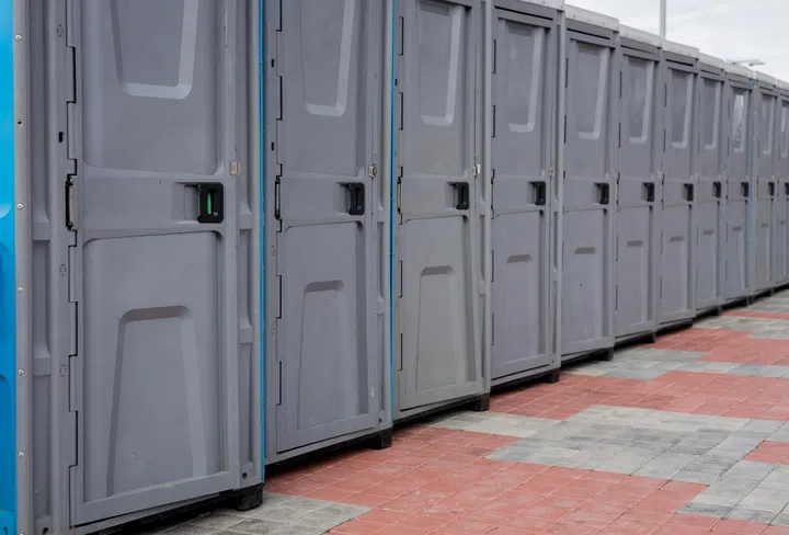 Row outdoor portable plastic toilets. Public WC.