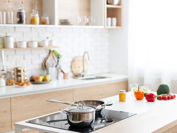 Modern kitchen interior at home with cooking dishes on stove, free space