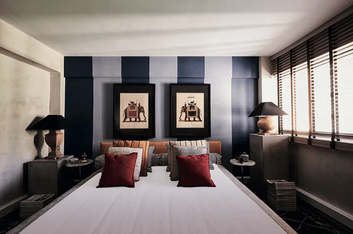 The bedroom is a picture of symmetry, but spot the slight difference: the height of the concrete pedestals!