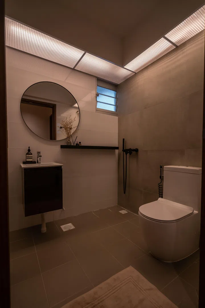 Wall-mounted fixtures and mirror cabinets keep the space streamlined, efficient, and easy to maintain.