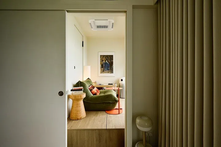 Raised on a timber platform, the compact room off the master bedroom is set apart as a quiet, elevated nook.