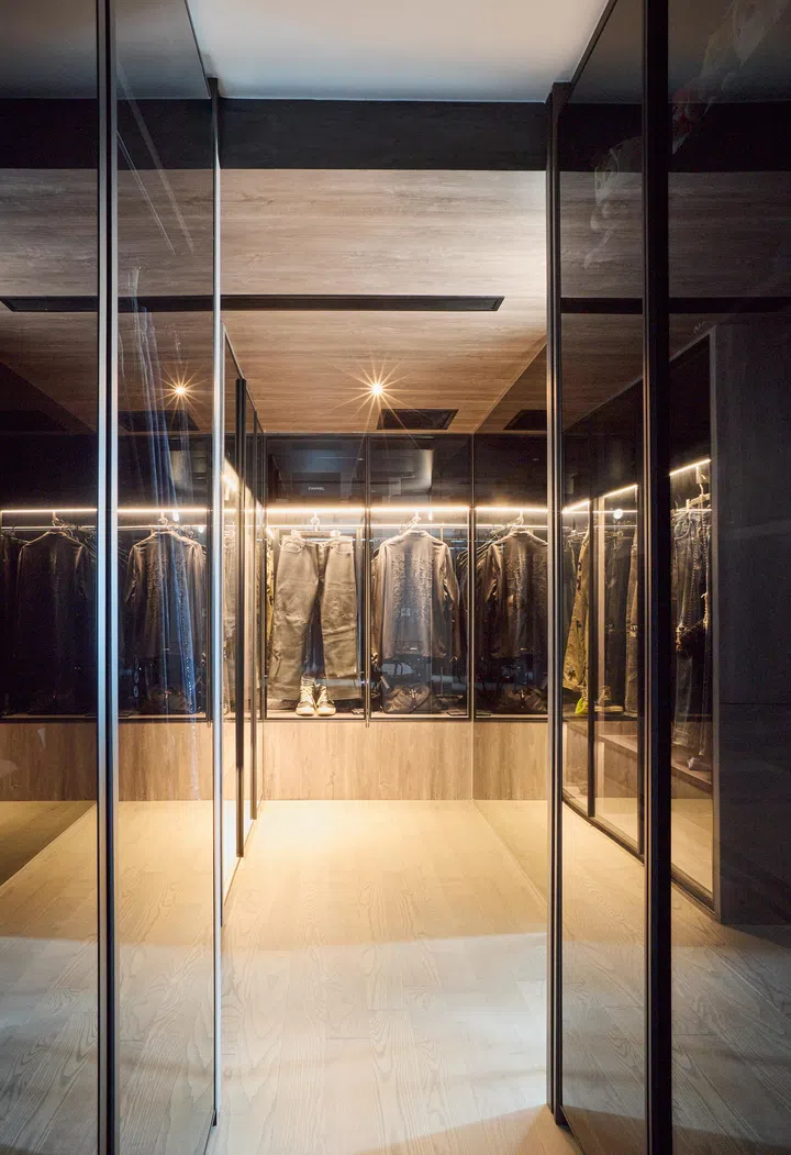 Mirrored door panels open up to a walk-in wardrobe.