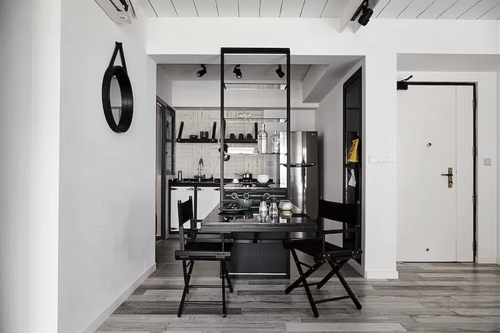 In this industrial loft-style 3-room HDB BTO in Punggol, the seemingly “floating” dining table that extends from the kitchen island, provide sufficient space for the homeowners to work and dine at.