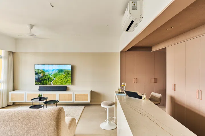 The living room is clad in creams and browns.
