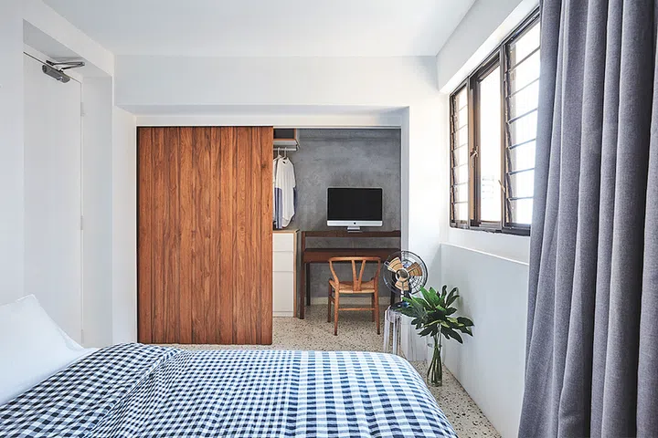 This homeowner prefers Japanese-style interiors, where spaces are hidden and don’t really interact with the living area. A wood divider separates wardrobe and study from the main sleeping area. Interior design by homeowner.
