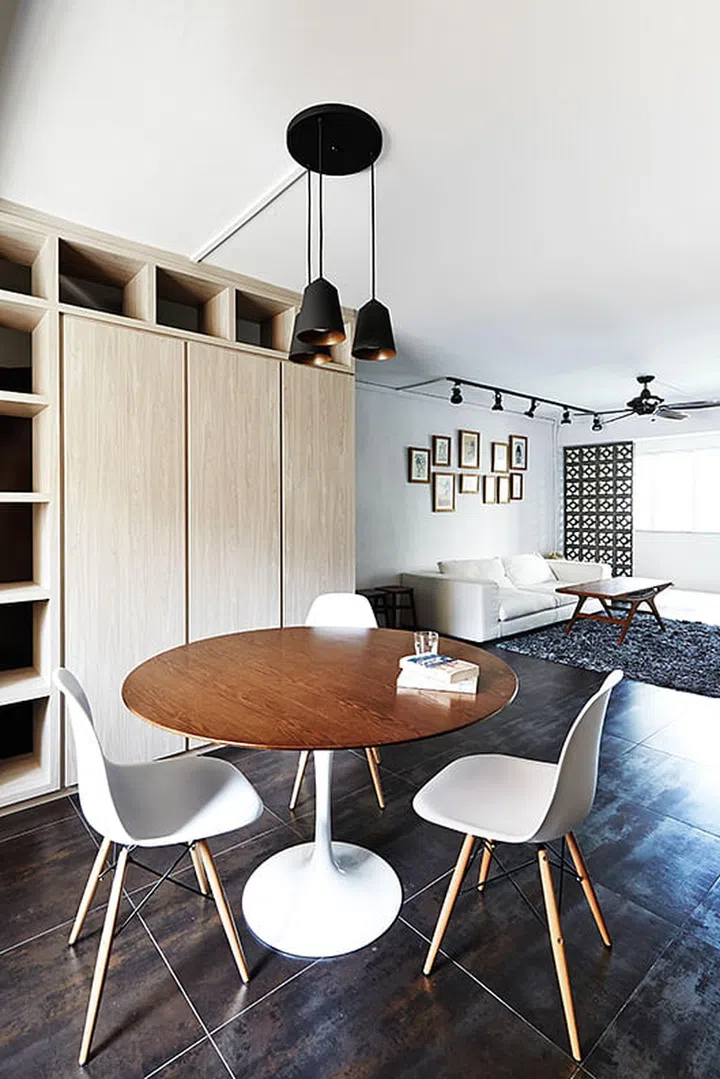 A built-in divider-cum-storage cabinet separates the dining room from the entrance foyer. Interior Design by The Design Practice