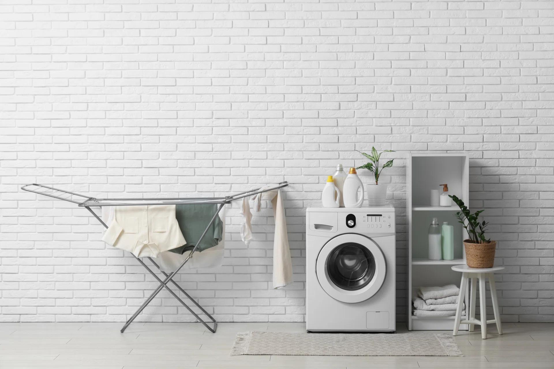 Interior of light laundry room with washing machine and dryer