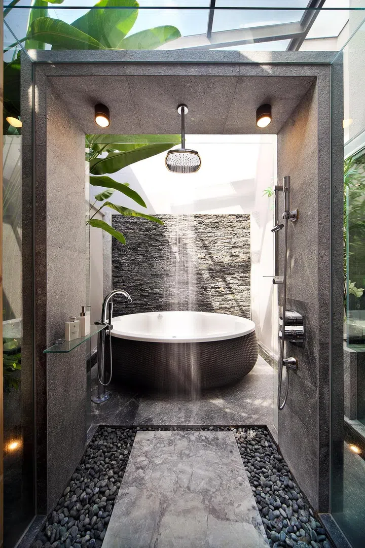 This architectural bathroom space is such a vision. We love its modern take on the resort style – the standing shower frames the very inviting bathtub nicely too! Interior design by Haire Living. The Senerade condominium at Holland Road