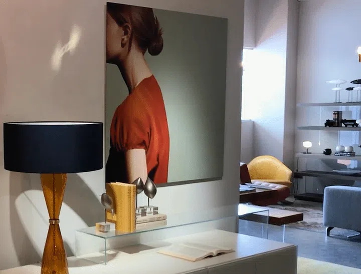 A large artwork hanging on the wall, above a long sideboard or console.