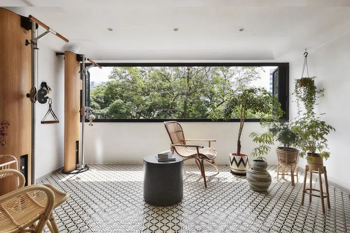 Spacious, sun-lit balcony area with rattan chairs and planters in a 1,367 sq ft 5-room HDB at Bedok Reservoir Road.