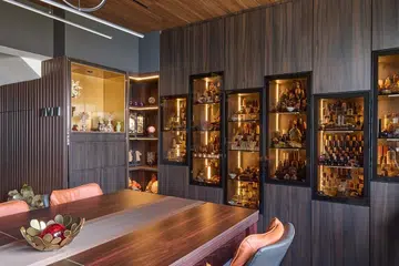 Glass wall display cabinet houses the homeowner's crystal collection in a HDB Executive Maisonette in Pasir Ris.