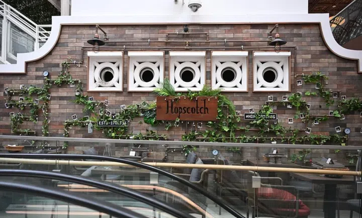 The DIY-ed exposed brick and copper pipe feature wall that has become a signature for Hopscotch’s bars.