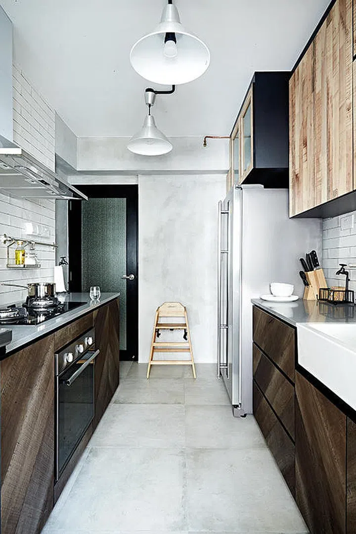 [Renovation costs: $45,000] In line with the industrial theme, the kitchen has concrete-screed surfaces and laminated cabinets with rugged wood textures.