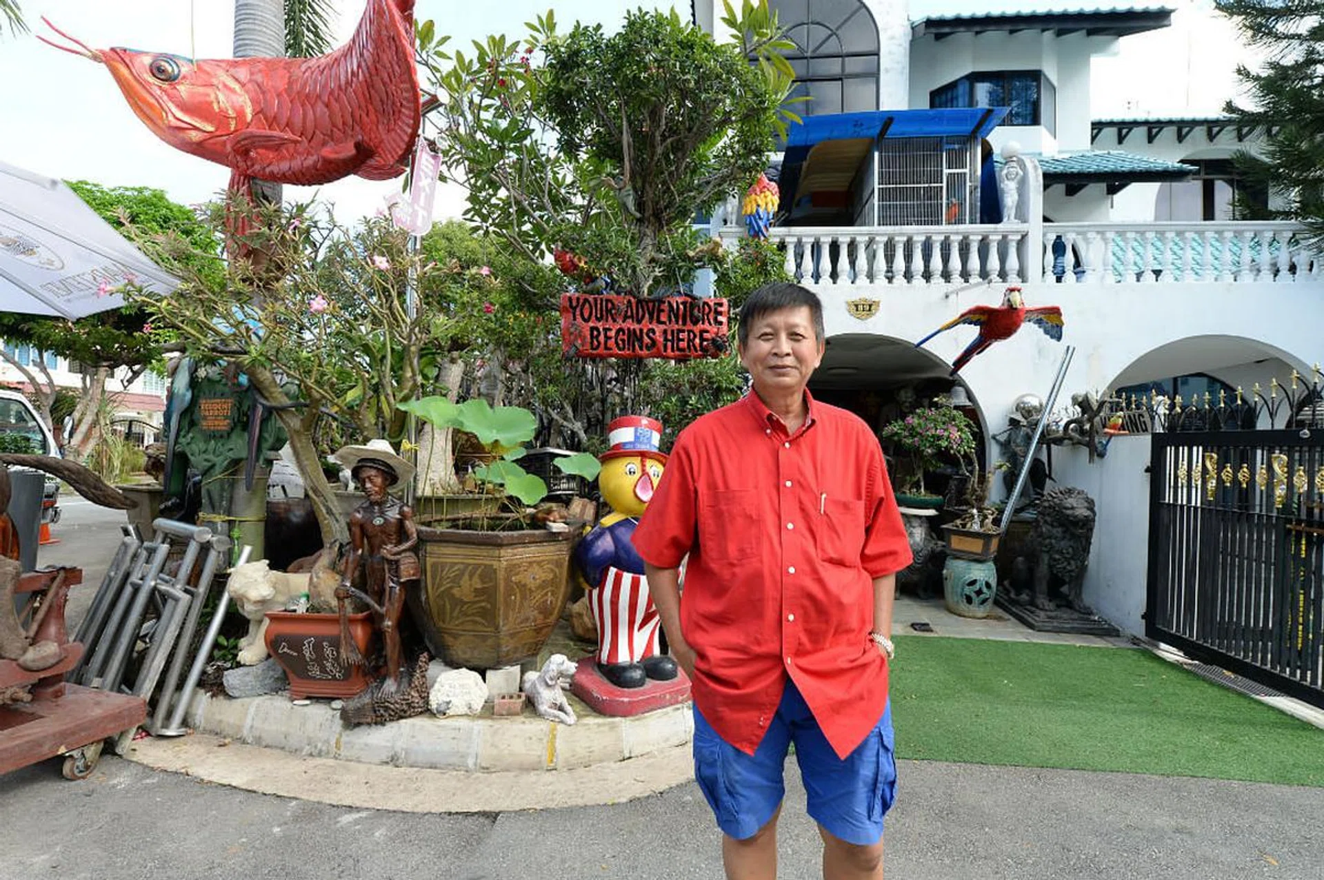 Semi-retired towkay Cheong Boo Wee poses for a photo in front of his famous Jalan Chempaka Kuning landed house.