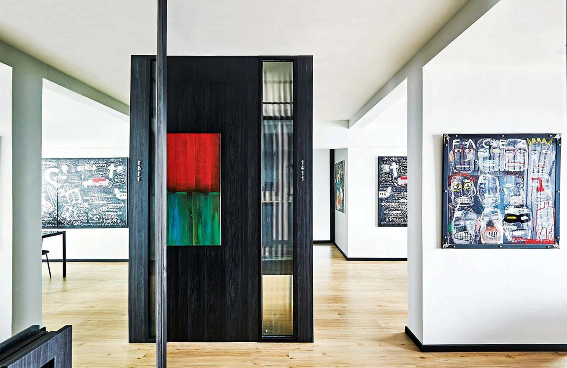 A home art gallery with art hanging on the walls. Interior design by Wee Studio